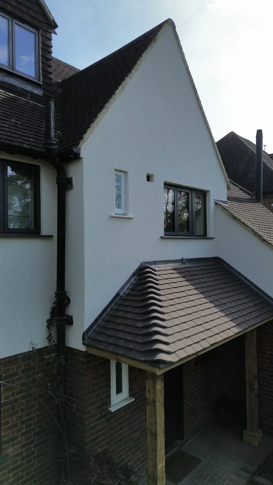 House extension with render and pitched tile canopy roof — builders Hampton Surrey