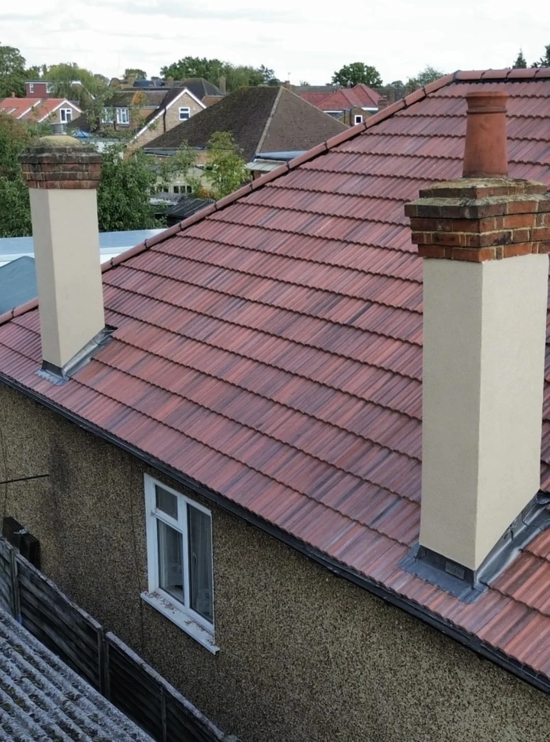 Pitched tile roof replacement with twin chimneys — roofers Richmond Surrey
